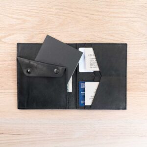 The field note wallet has a slot for your small field journal behind the coin pouch.